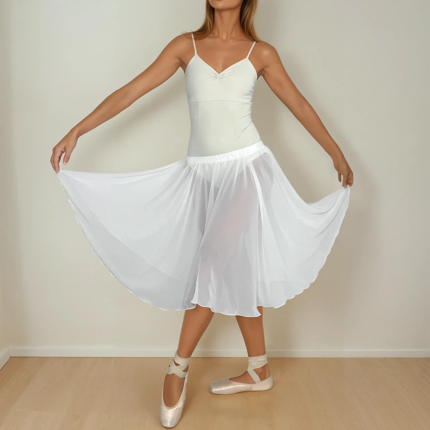 Woman in a white dress standing against a plain background