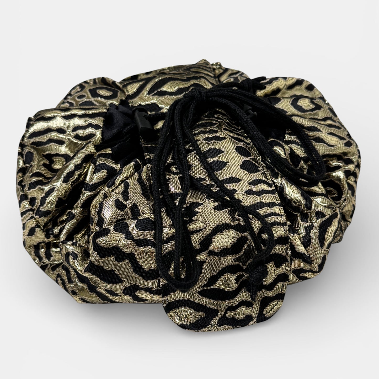 Gold and black patterned drawstring bag on a white background