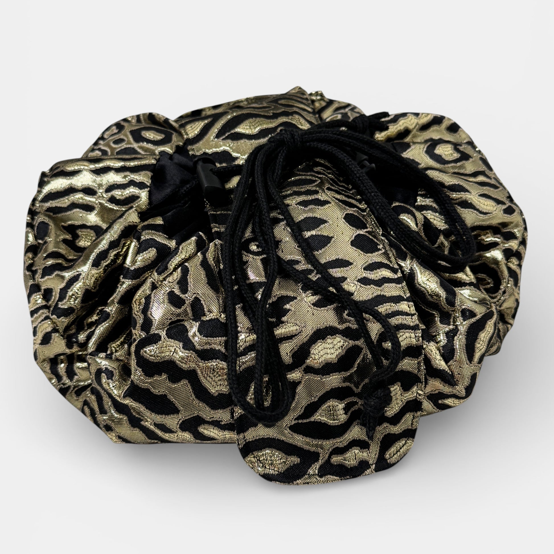 Gold and black patterned drawstring bag on a white background