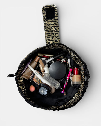 Makeup bag with cosmetic products on a white background